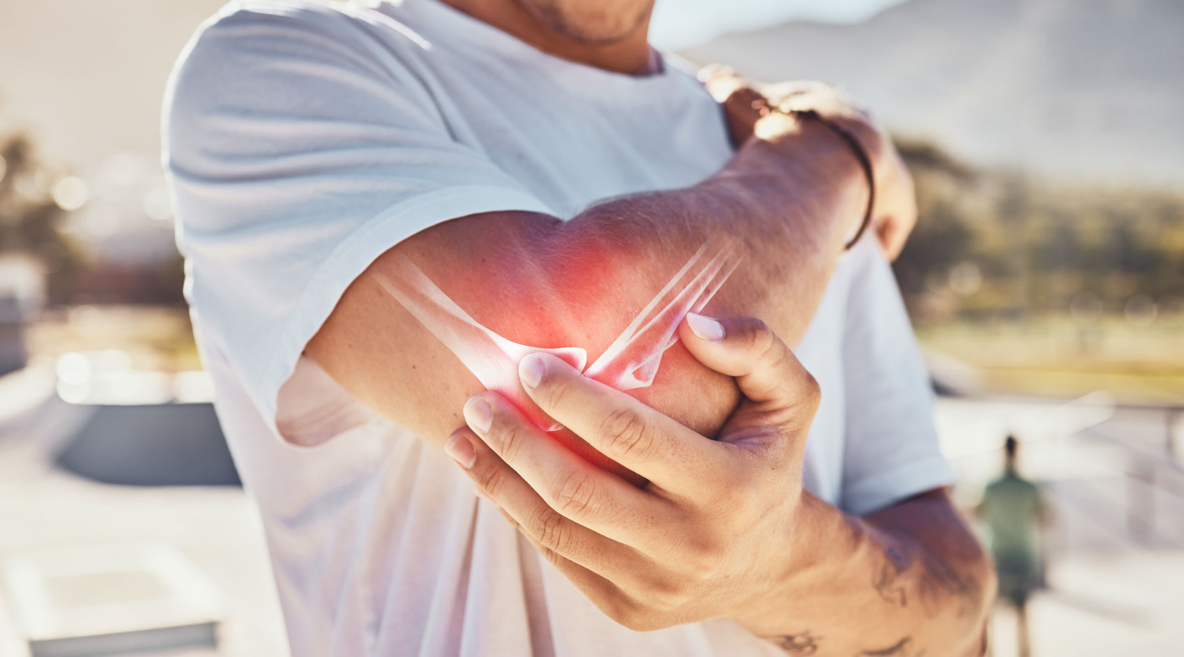 Person holding painful, inflamed elbow with visible bones indicating joint pain or injury.